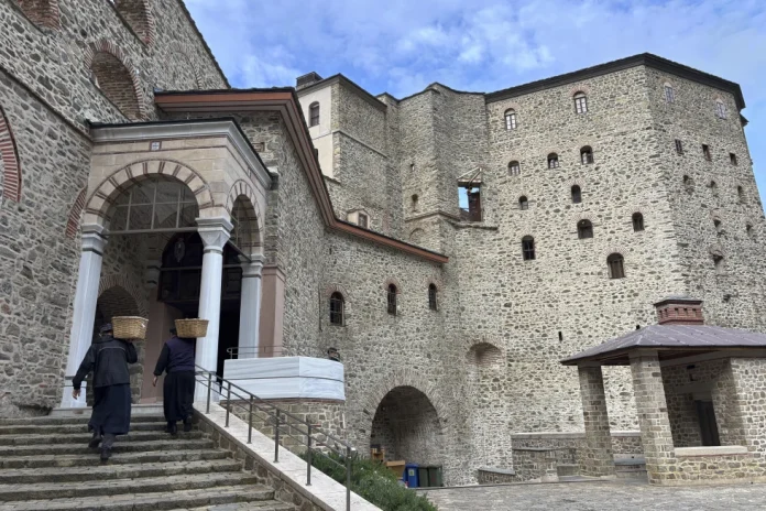 Monks carry baskets of supplies to the Simonos Petra Monastery in the self-sustaining community of monks at Agion Oros on the Mount Athos peninsula in northern Greece, April 15, 2025. (AP Photo/Thanassis Stavrakis, File)