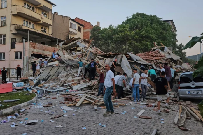 People remove the wreckage of a collapsed building following an earthquake in Sindirgi, northwest Turkey, Sunday, Aug. 10, 2025. (Bahadir Demirceviren/IHA via AP).webp